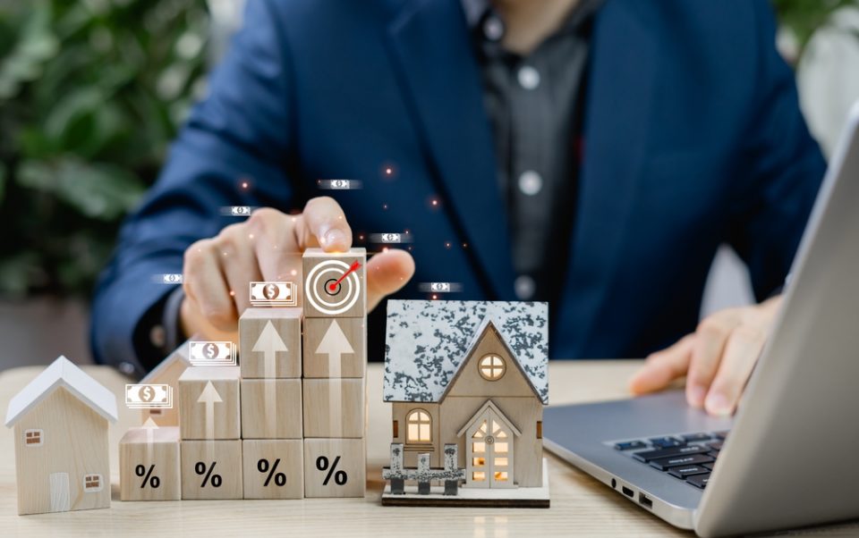 Businessman reviewing real estate investment plans and property documents, highlighting UK rental legislation changes affecting Rochdale landlords in 2026.
